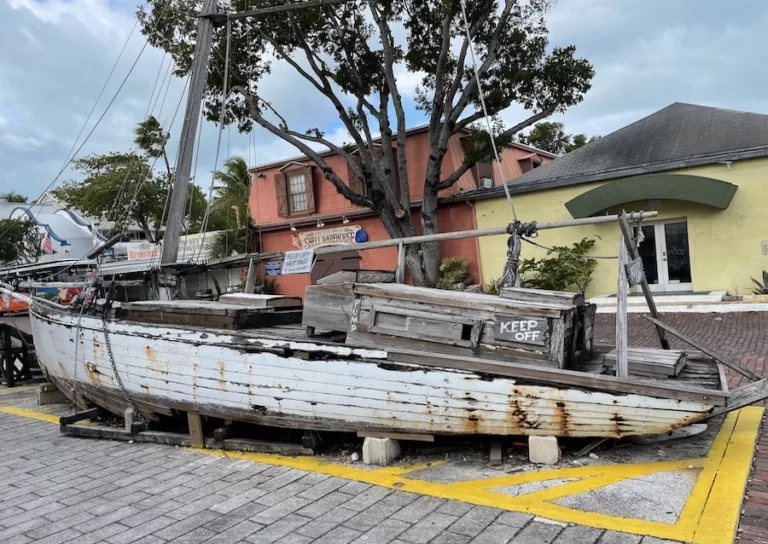 Key West, Florida - Ship wreck in the main square surrounded by colorful buildings and palm trees