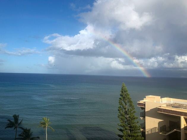 Oceanview with clouds in the sky and a beautiful rainbow. 