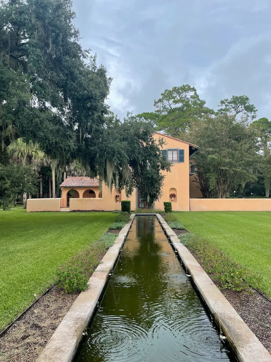 Villa Marianna Cottage on Jekyll Island - old orangish cottage with long pond in front of it 