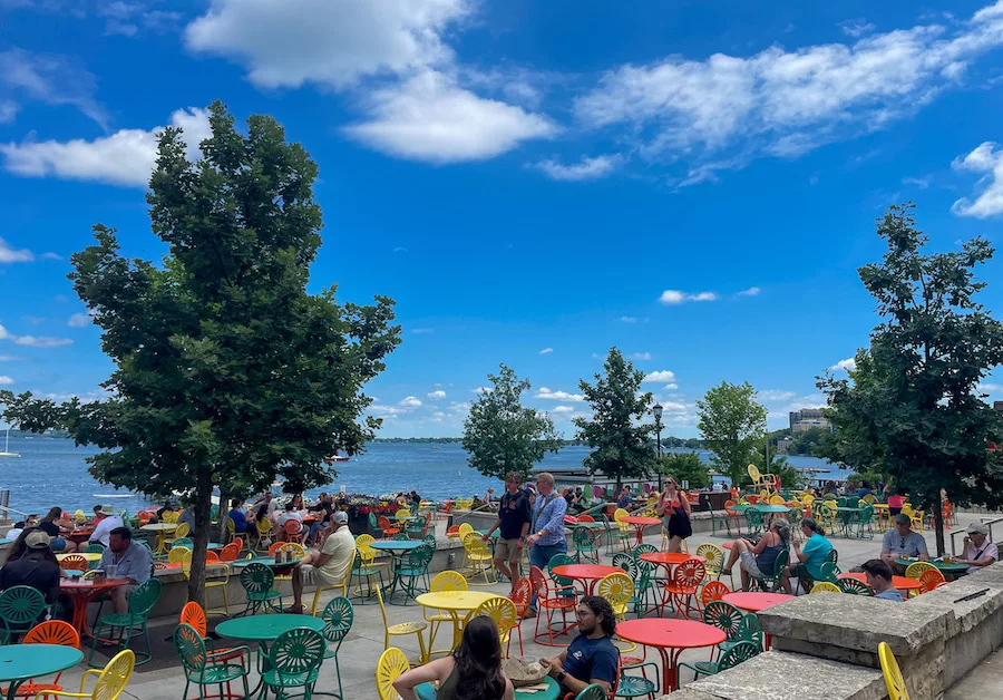 Colorful chairs and tables filled with people at the Memorial Union Terrace. 