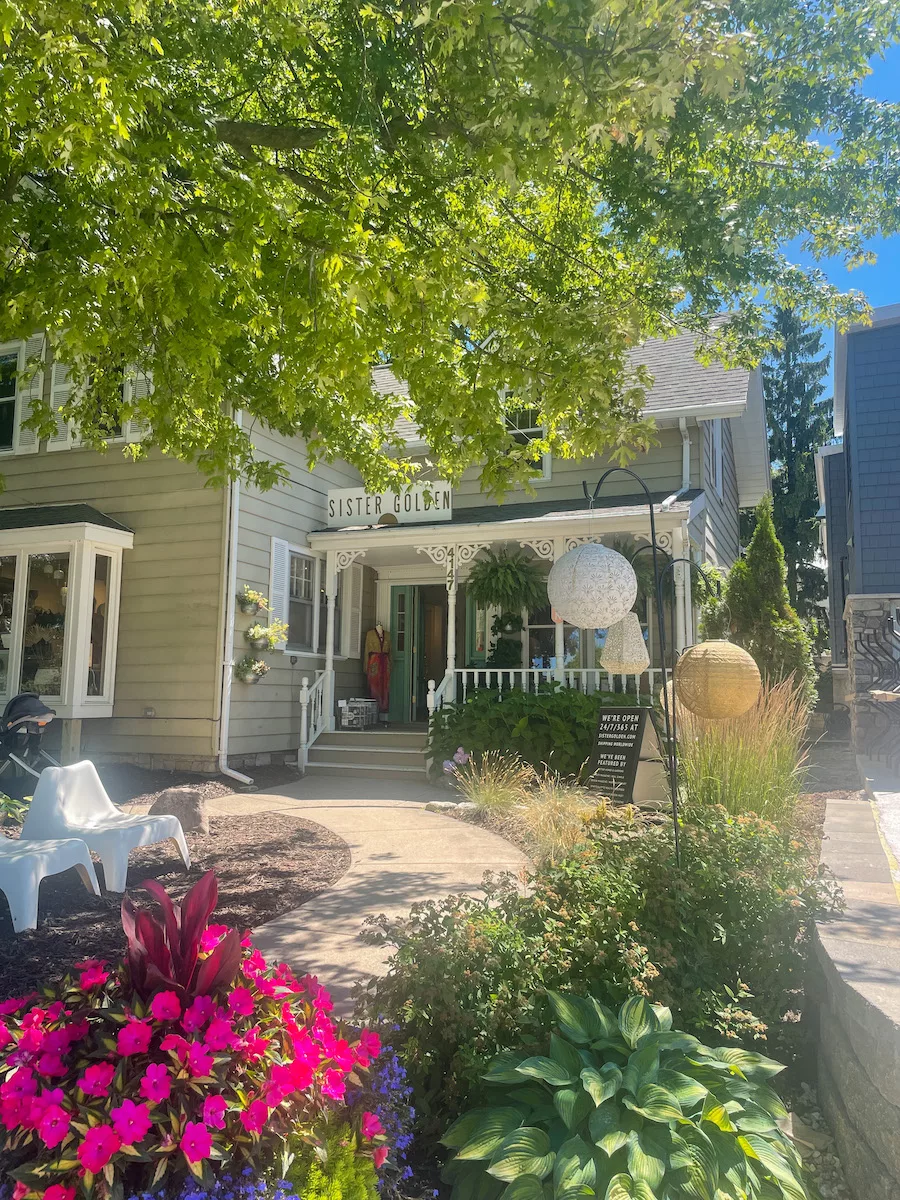 Sister Golden store in Door County surrounded by trees and bright, summery flowers.