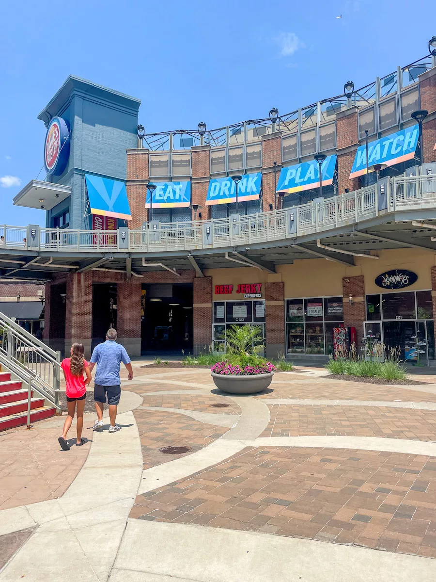 Things to do in Kansas City - Two individuals walking in an outdoor mall area. 
