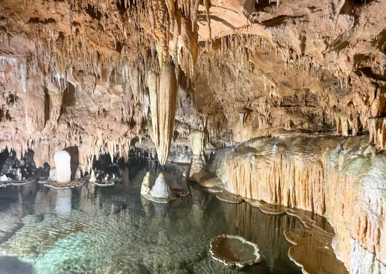 Caves in Missouri - View of Lily Pad Room at Onondaga Cave State Park. Inside of cave filled with clear, blue water.
