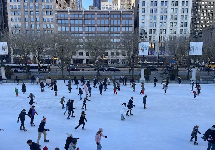 Best Holiday Vacation Destinations - Chicago Illinois image of individuals ice skating in Millennium Park