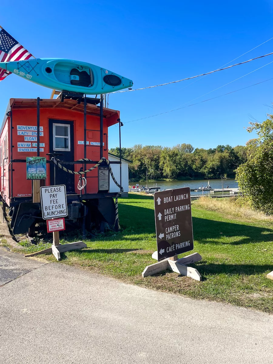 Orange trailer with kayak and American Flag on top that houses cSavanna Adventures. 