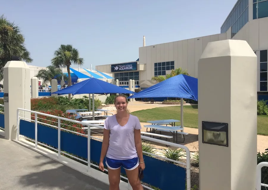 Woman posing outside of the Texas State Aquarium