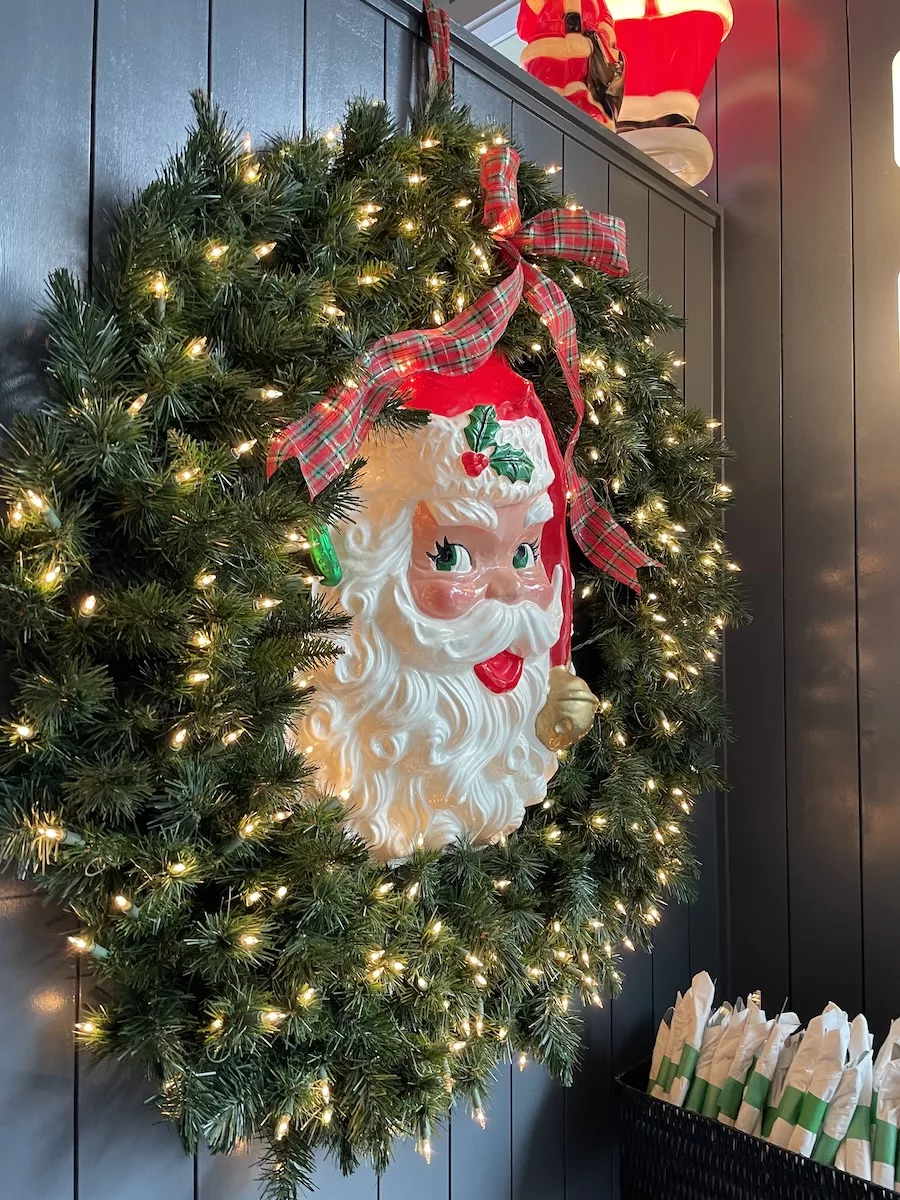 Lit-up wreath with santa's face in the middle of it