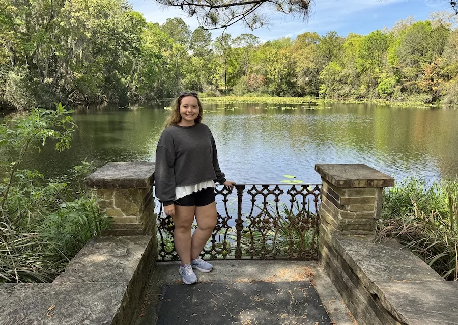 Woman posing in front of a lake at Jacksonville Arboretum & Botanical Gardens 