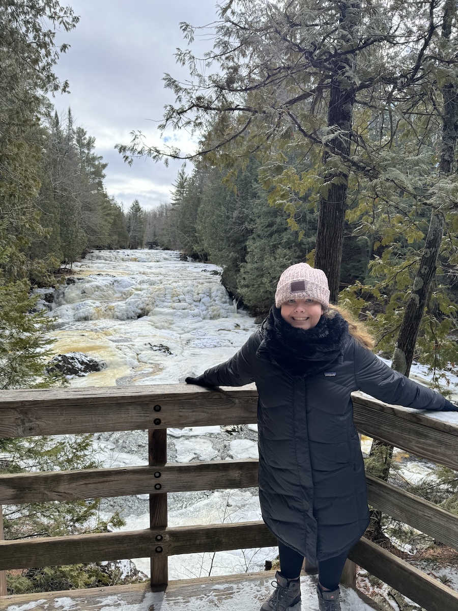 Young woman at overlook to cascades in Copper Falls State Park