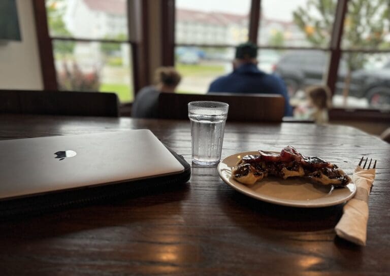 Image of laptop, croffle, and water glass at Eb Flo Coffeehouse - Best Restaurants in Sheboygan