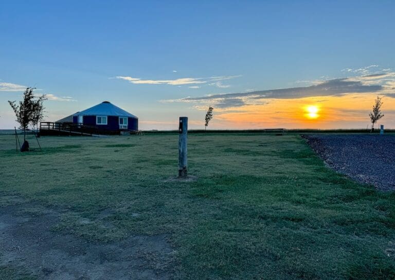 Image of cabin and sunset surrounded by grass in Southern Kansas