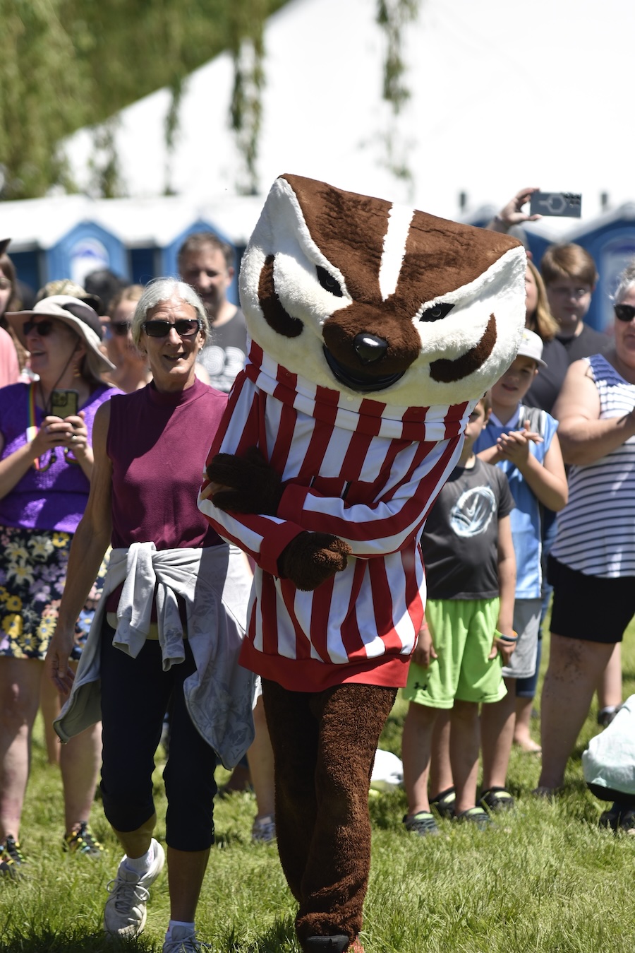 Image of Wisconsin's Bucky Badger surrounded by people at the Brat Fest in Madison, WI