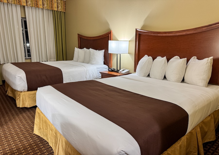 Image of Two Beds with a nightstand and lamp inbetween - Best Western Grand Island - Weekend in Grand Island