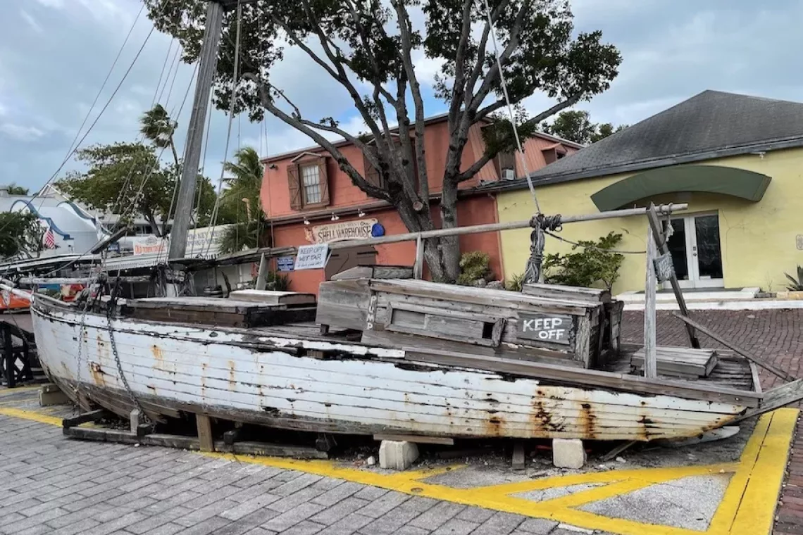 Key West, Florida - Ship wreck in the main square surrounded by colorful buildings and palm trees